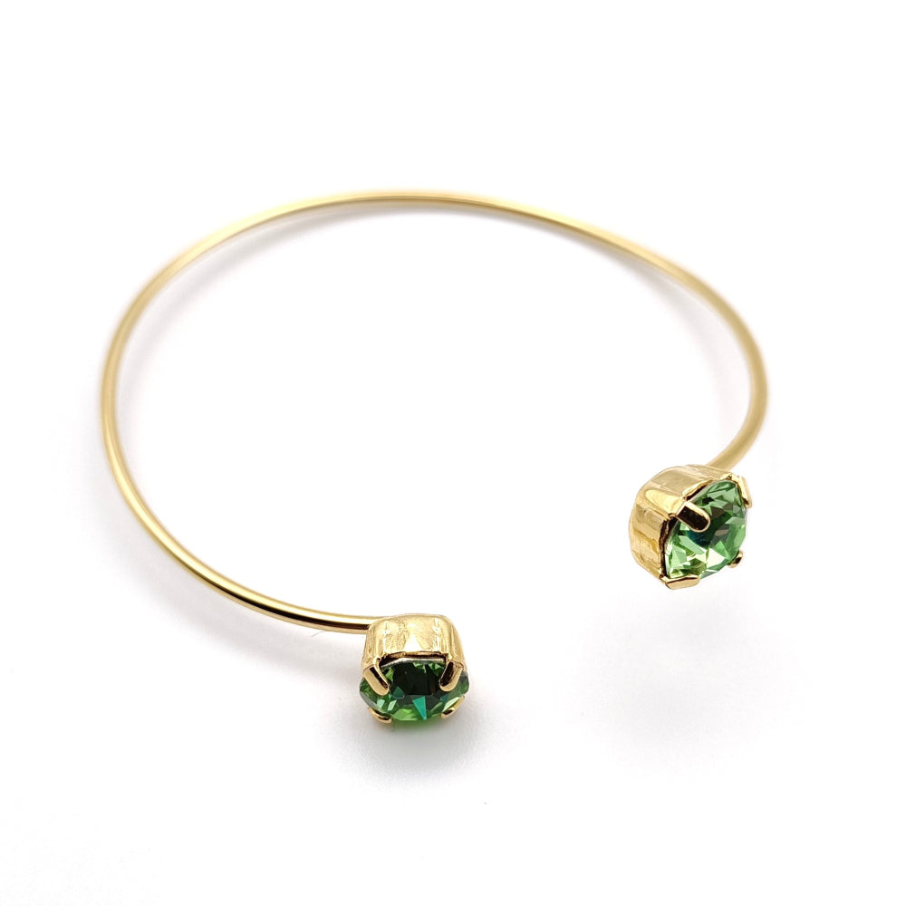 Bracciale rigido di ungioielloperte.com in metallo dorato e cristalli Swarovski verdi